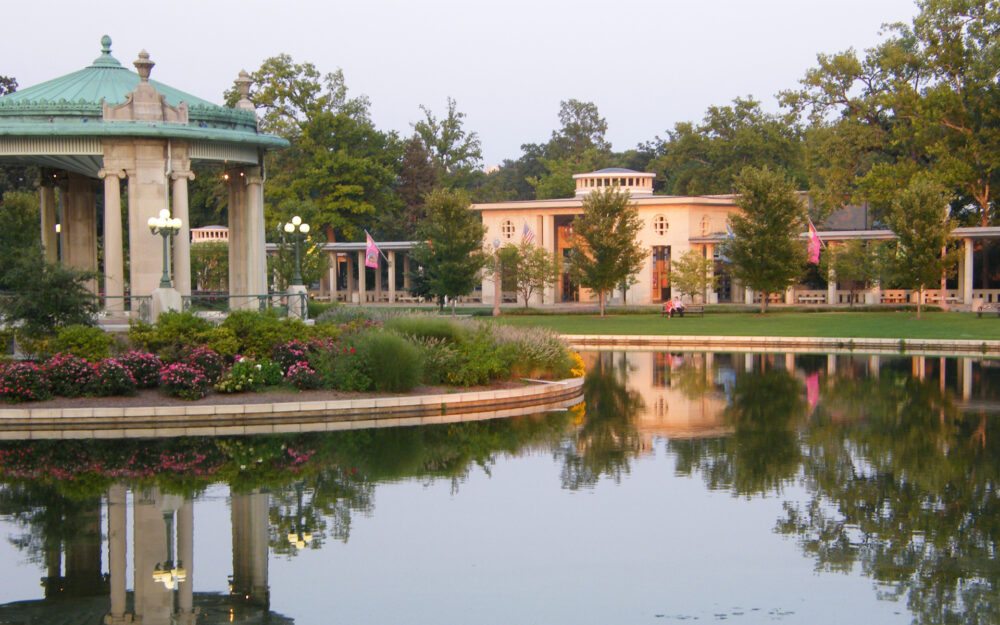 A photo of The Muny from the front of the building, featuring lake parallaz and the gazebo in Forest Park. Second Century Campaign.