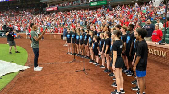 The Muny Kids, under the direction of Daniel McRath, perform the national anthem June 25, 2024, before a Cardinals game at Busch Stadium.