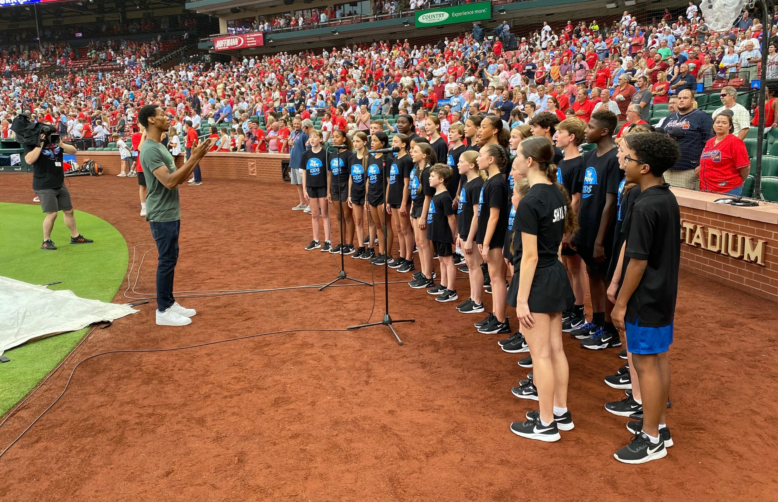 The Muny Kids, under the direction of Daniel McRath, perform the national anthem June 25, 2024, before a Cardinals game at Busch Stadium.