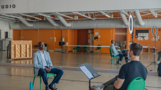 Behind-the-scenes photo of on-camera interview with Muny President & CEO Kwofe Coleman in a rehearsal studio at The Muny
