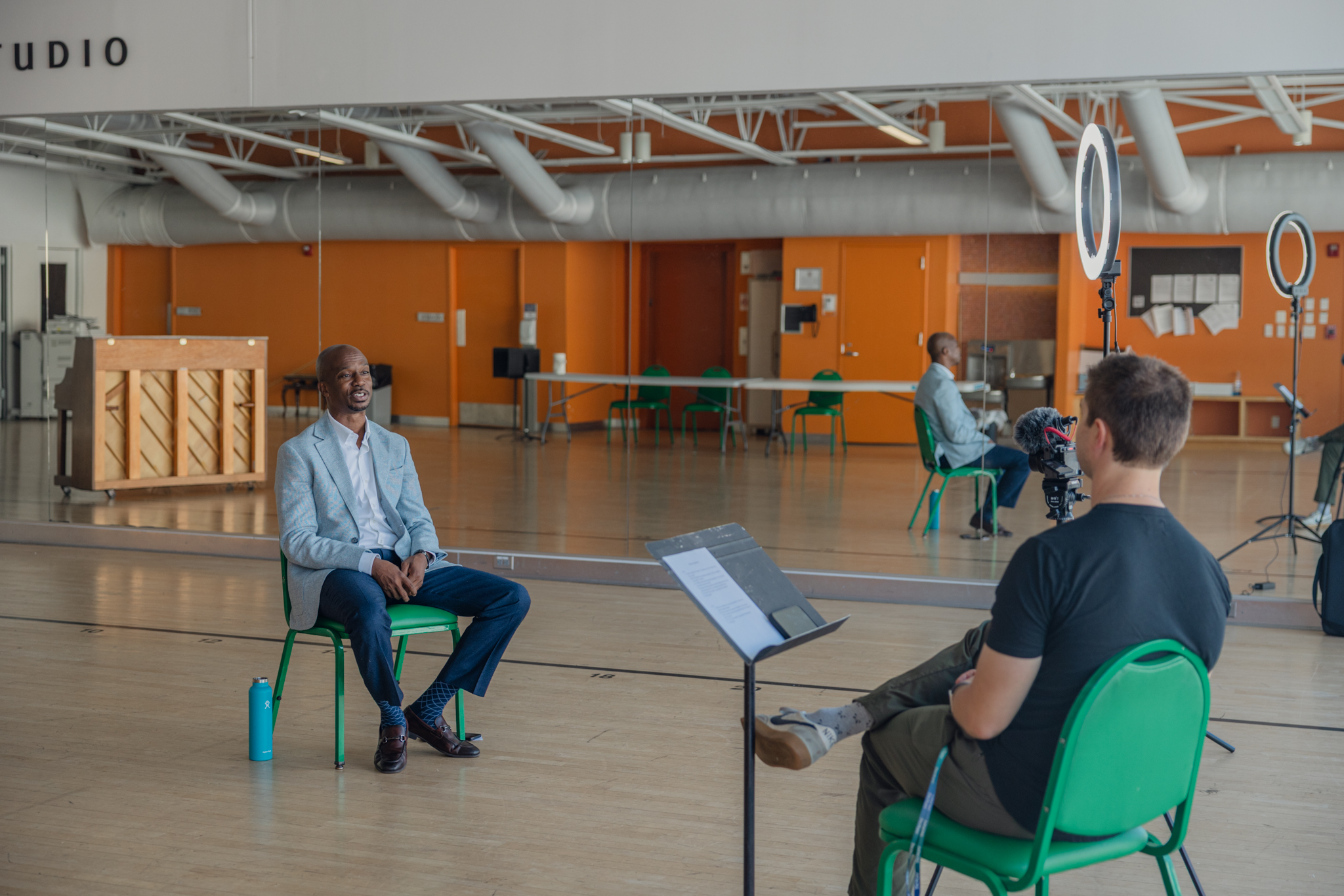 Behind-the-scenes photo of on-camera interview with Muny President & CEO Kwofe Coleman in a rehearsal studio at The Muny