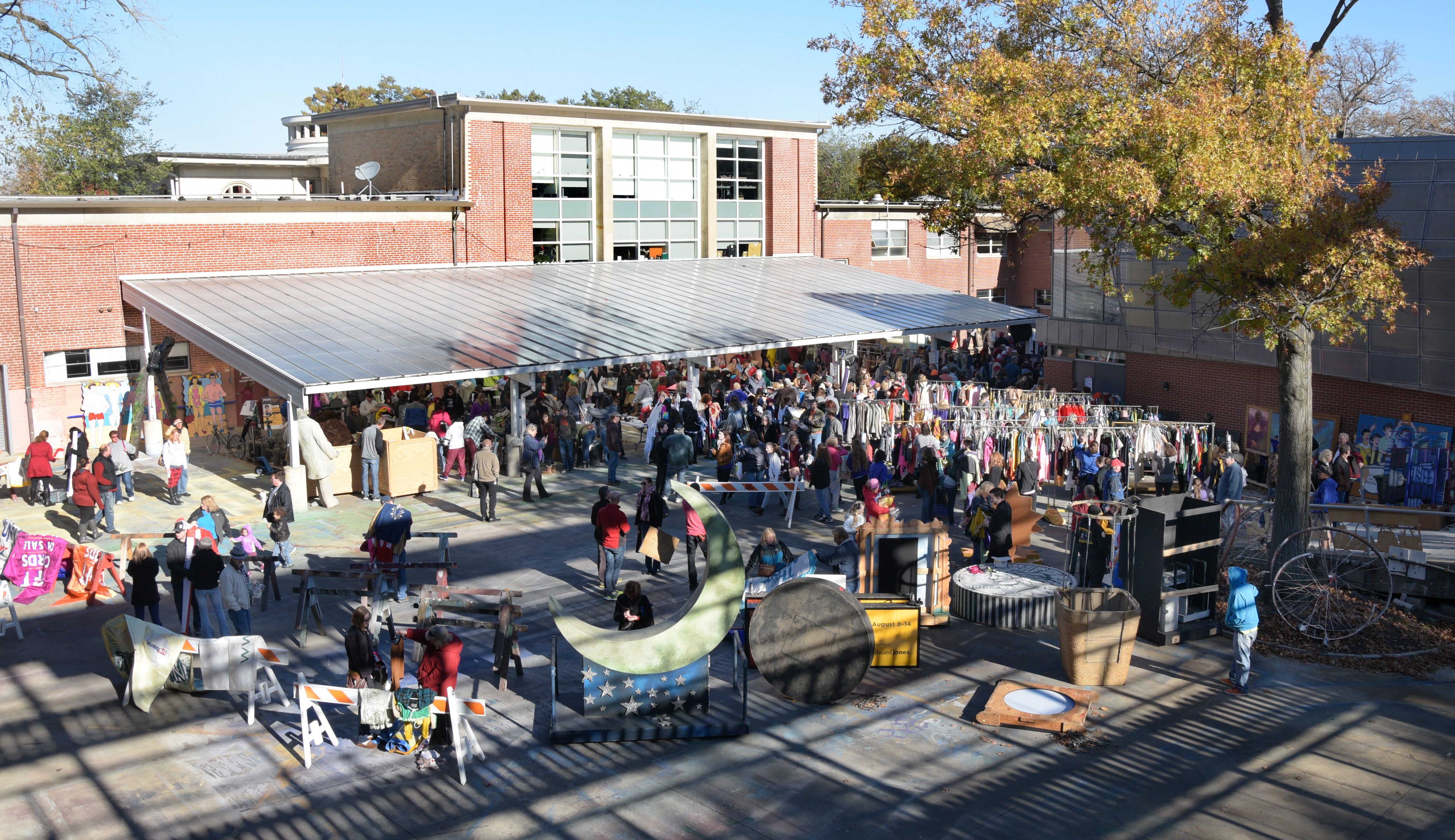 Shoppers browsing merchandise backstage at the Muny Garage Sale in 2016