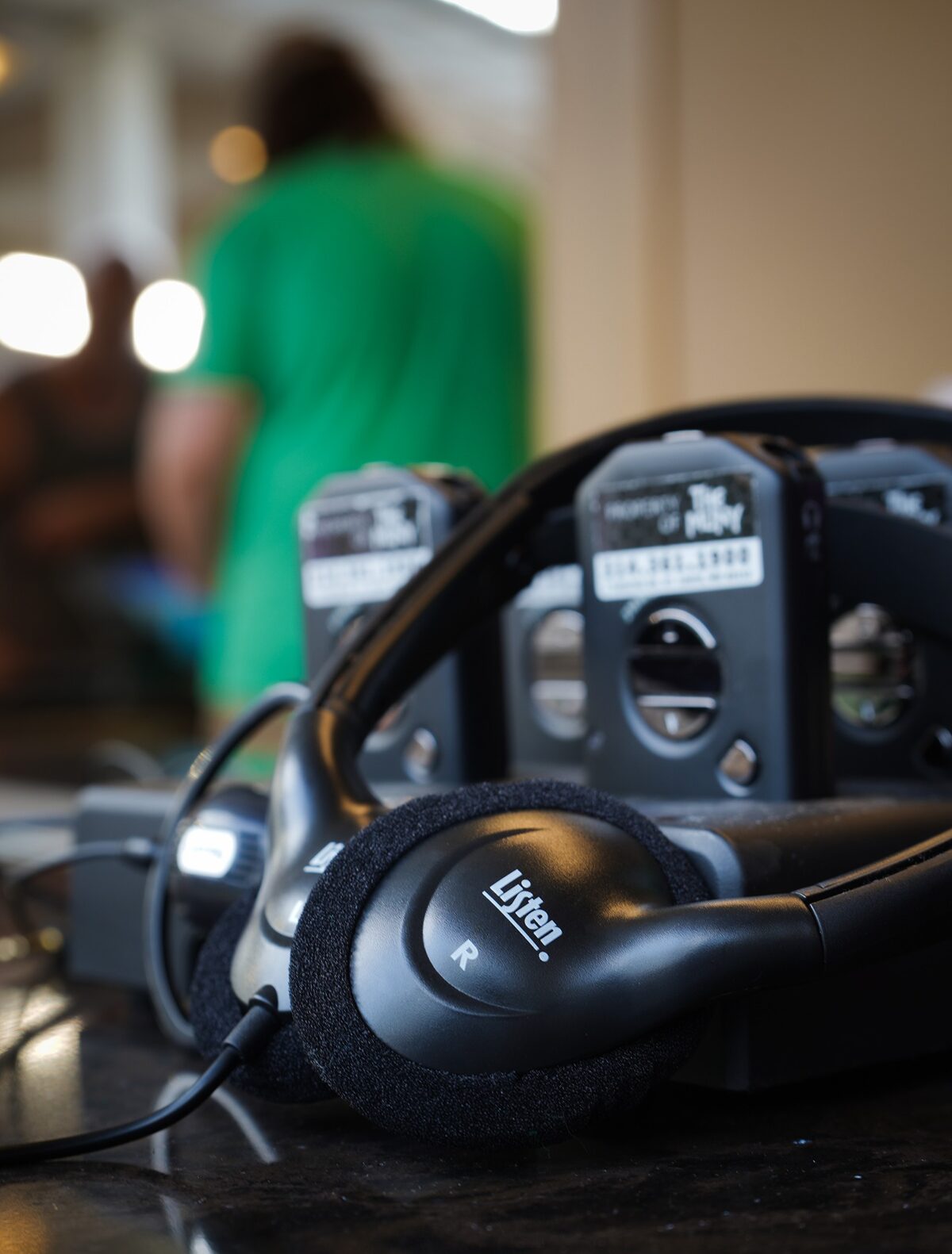 A close-up photo of Muny audio description listening devices